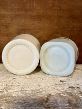 Load image into Gallery viewer, two cold creme milk glass jars, marked lids
