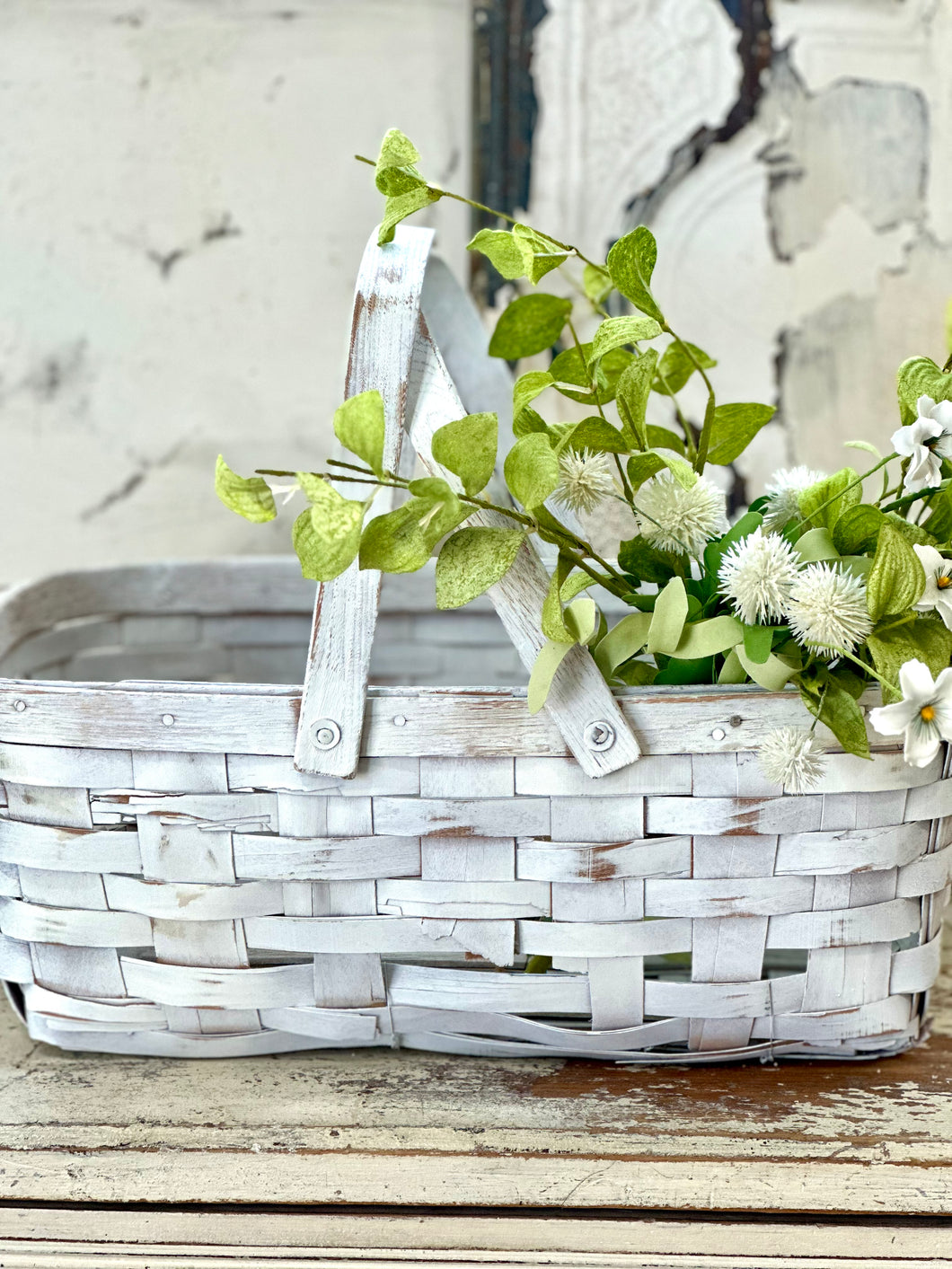 white damaged gathering basket with swinging handles