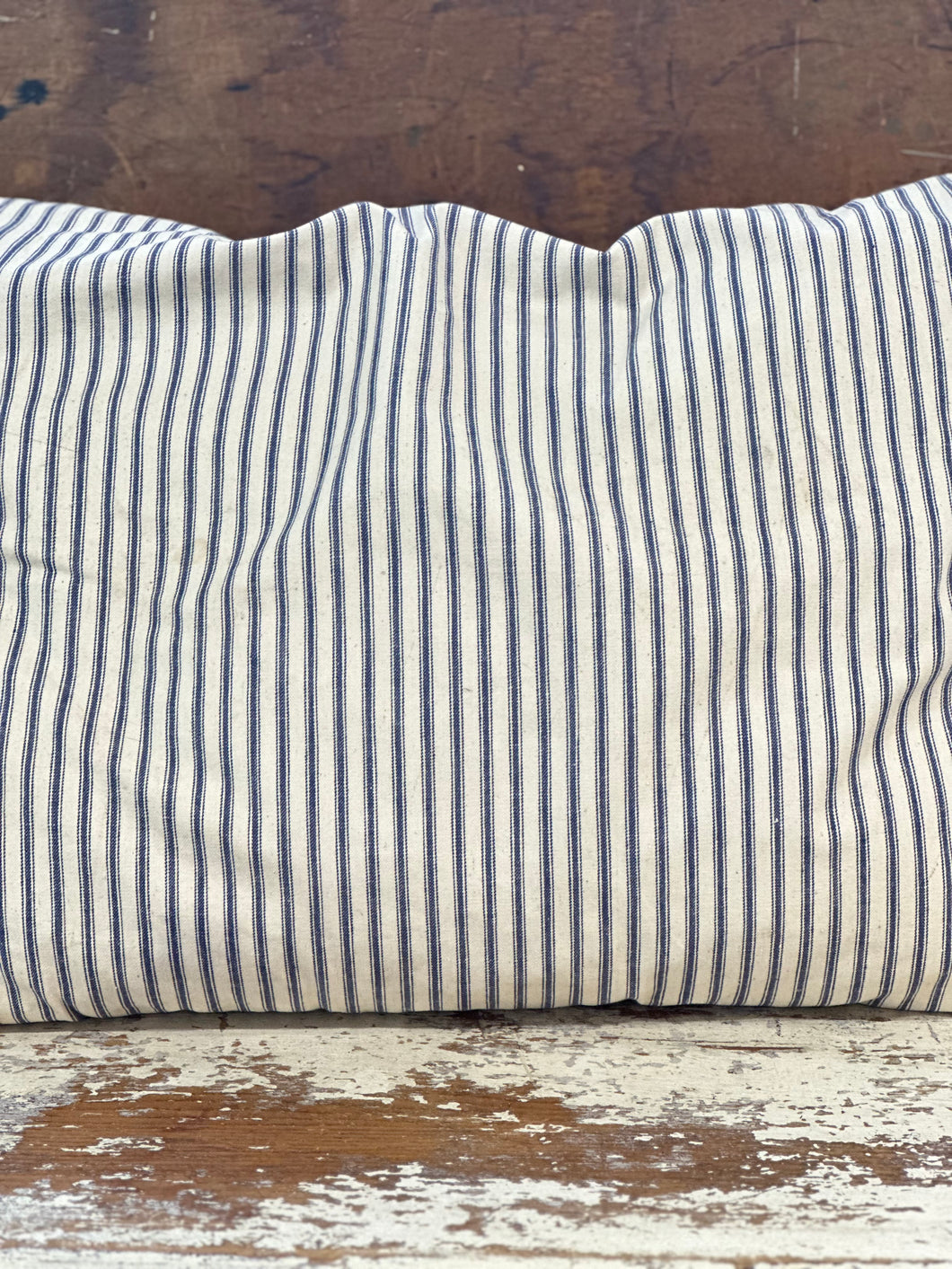 blue ticking pillow, some light staining/vertical stripes